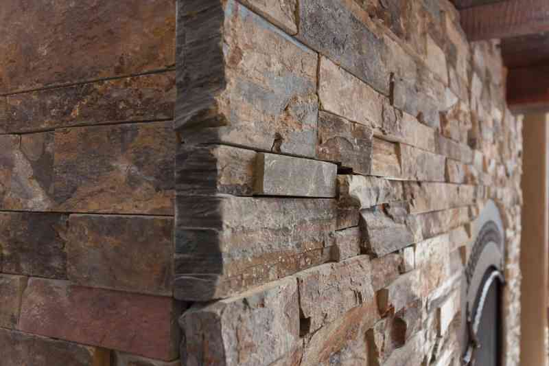 A detailed view of the tapered stone edge on the interior fireplace.