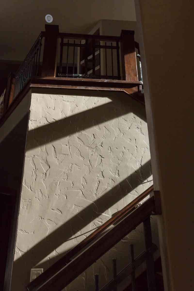 All of the walls were hand-scraped texture as can be seen on this stairway.