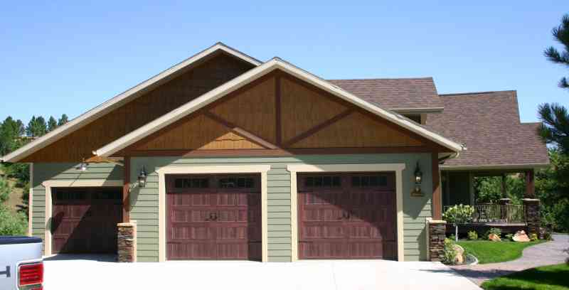 A spacious 3-car garage with gorgeous wooden doors!