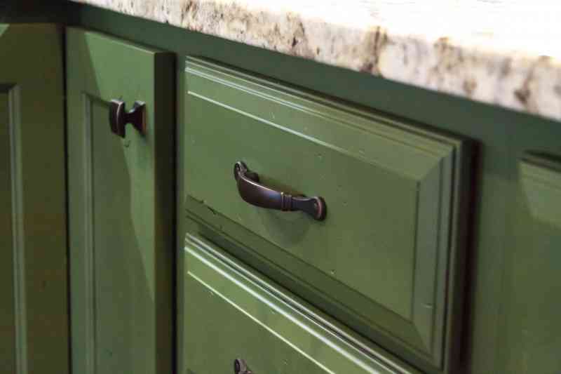 The green cabinets came with rustic details.