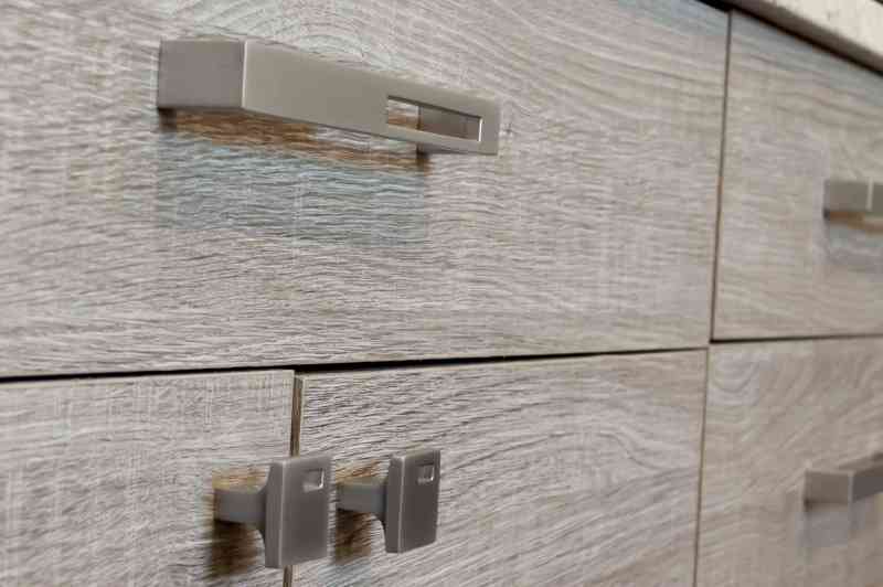 The kitchen cabinets are finished off with brushed nickel hardware.