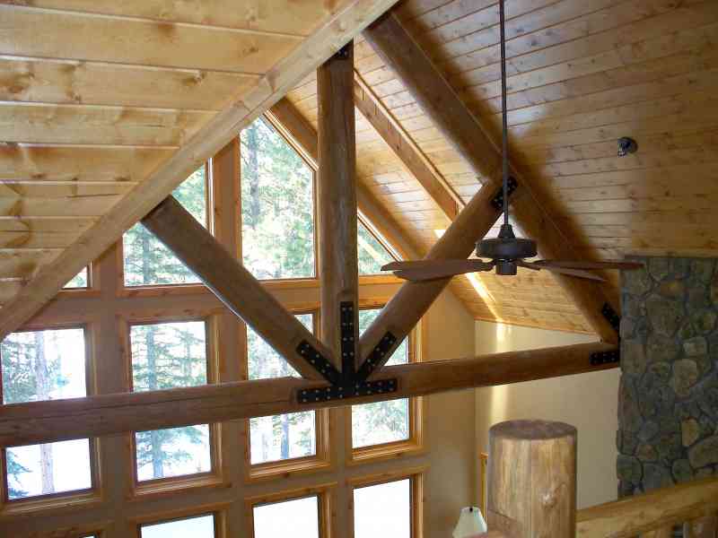 A log truss designed with steel plate accents.