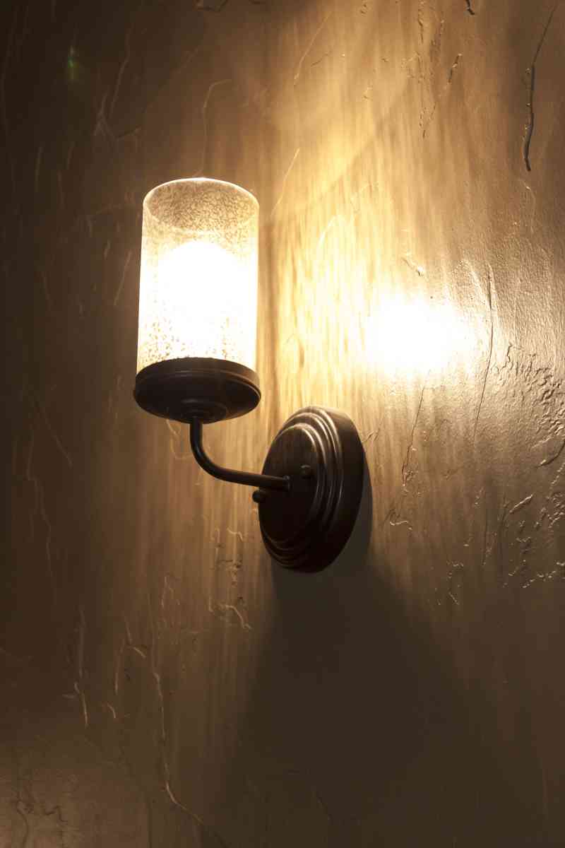 Lighting emphasizing the hand-scraped wall texture.